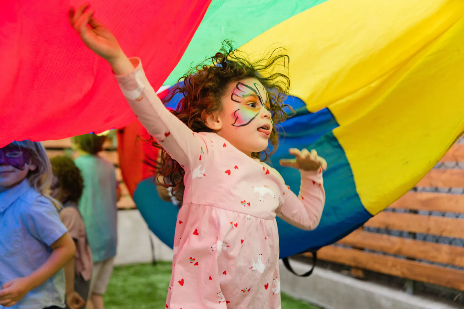 Children enjoying superhero play outdoors